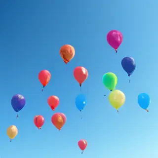 Exactly 11 colorful balloons floating against a clear blue s
