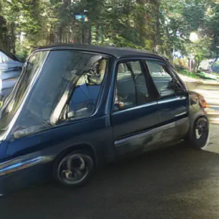 A car body with windows, doors, and headlights but no wheels