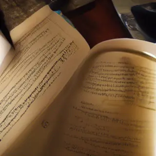 A coffee mug next to an open book on a desk