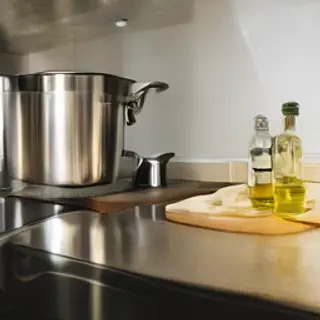 A kitchen counter with a stainless steel pot, a wooden cutti