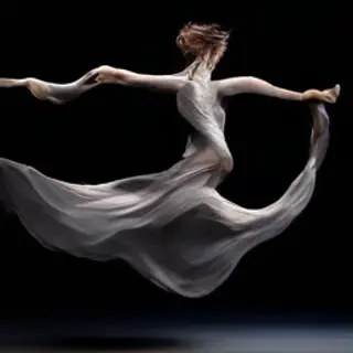 A dancer in a dynamic spin, dress flowing outward with one l