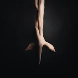 A person standing with both hands visible at their sides, fi
