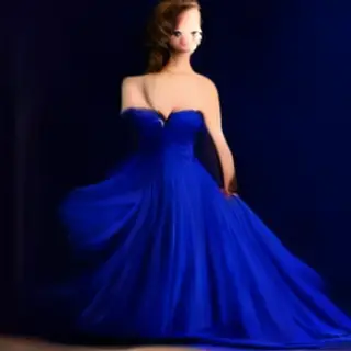 A woman wearing a royal blue evening dress against a neutral