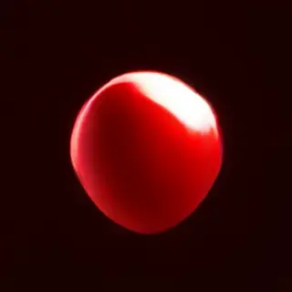 A red sphere on a white surface with a single shadow cast to