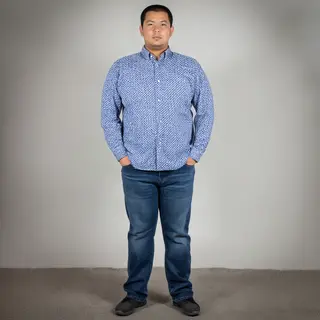 A man standing straight facing the camera, hands in pockets,