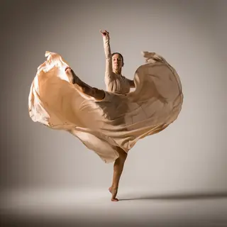 A dancer in a dynamic spin, dress flowing outward with one l