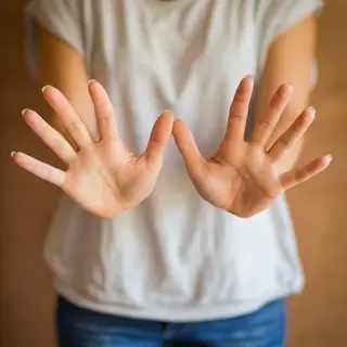 A woman holding her hands out in front of her palms-up, all 
