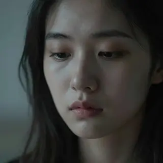 A face showing quiet melancholy — downcast eyes, slightly dr