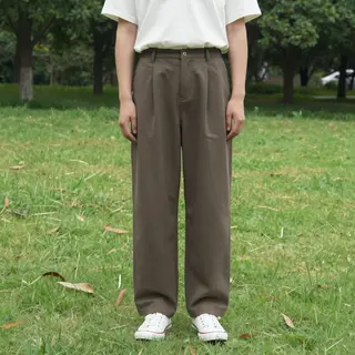 A person standing in a neutral pose in a park, full body vis