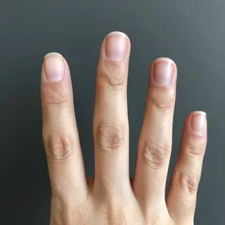 A person counting to three on their fingers, with index, mid