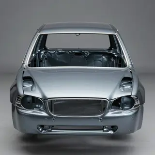 A car body with windows, doors, and headlights but no wheels