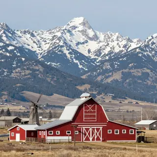 A landscape with a red barn in the foreground at large scale