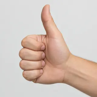 A hand giving a thumbs-up with four fingers curled and thumb