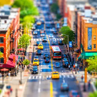 A tilt-shift photograph of a city street making real-life lo