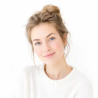 A high-key portrait of a person against a bright white backg