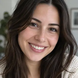 A close-up portrait of a young woman with a warm natural smi