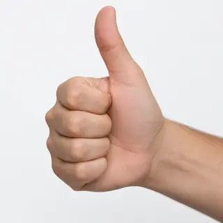 A hand giving a thumbs-up with four fingers curled and thumb