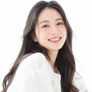 A high-key portrait of a person against a bright white backg