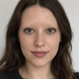 A human face with eyes, nose, and mouth but no eyebrows