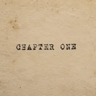 The word 'CHAPTER ONE' typed on aged paper with a vintage ty