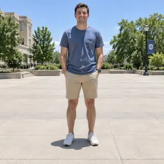 A person standing outdoors at midday with a short shadow dir