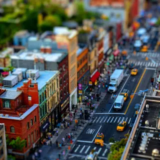 A tilt-shift photograph of a city street making real-life lo