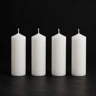 Exactly 4 white candles standing on a dark surface