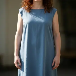 A person standing with both hands visible at their sides, fi