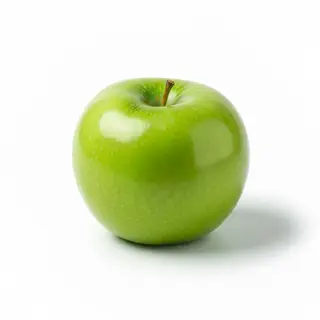 A ripe green apple on a seamless white background with soft 