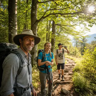 Three hikers on a trail: a man with a backpack and sunhat, a