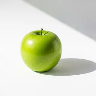 A ripe green apple on a seamless white background with soft 