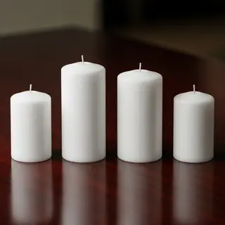 Exactly 4 white candles standing on a dark surface