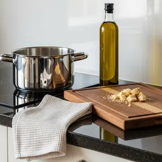 A kitchen counter with a stainless steel pot, a wooden cutti