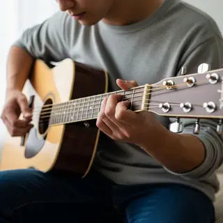 A person playing an acoustic guitar with left hand on the fr