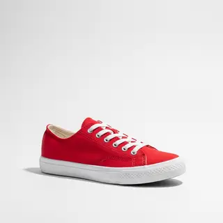 A single red sneaker on a clean white background with soft s