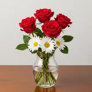 4 red roses and 2 white daisies in a glass vase on a table