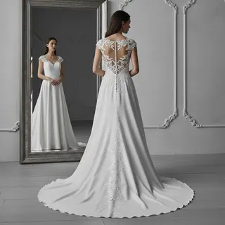 A woman standing in front of a full-length mirror, her refle