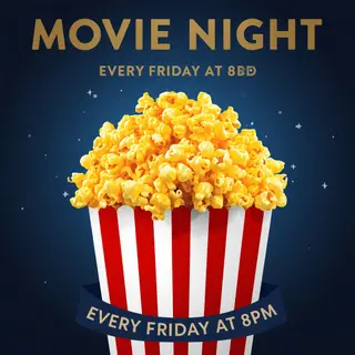 A movie night poster with a large popcorn image in the cente