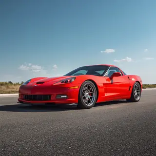 A bright red sports car parked on a gray asphalt road — the 