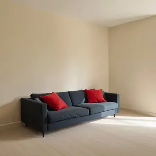 A minimalist room with walls in #F5E6CC (warm cream), a sofa