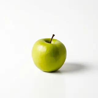 A ripe green apple on a seamless white background with soft 