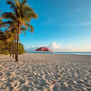 A sandy beach with palm trees, seashells, and a beach umbrel