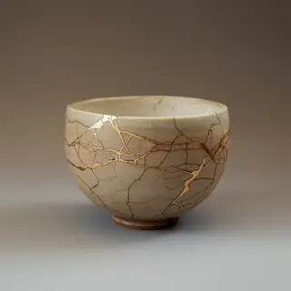 A Japanese kintsugi bowl — cracked ceramic repaired with vis