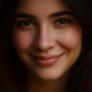 A close-up portrait of a young woman with a warm natural smi