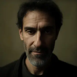 A portrait of a middle-aged man with a calm, serious express