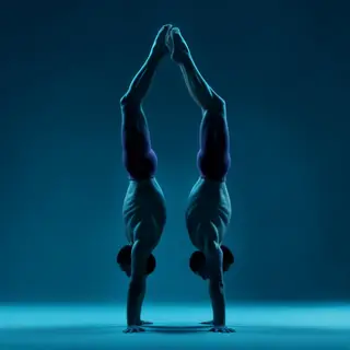 Two gymnasts performing a synchronized handstand, side by si