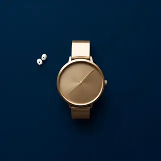 A product flat-lay on a #1A1A2E (deep dark blue) background,