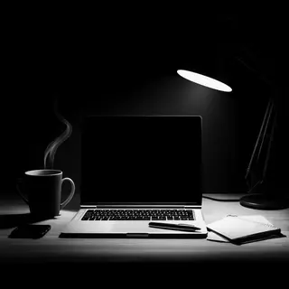 A desk scene: laptop in the center, coffee mug to the left, 