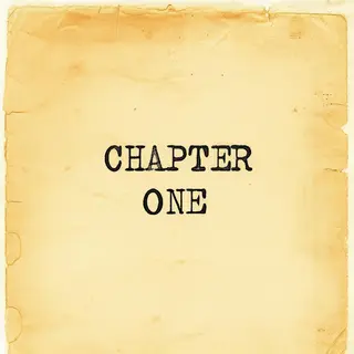 The word 'CHAPTER ONE' typed on aged paper with a vintage ty