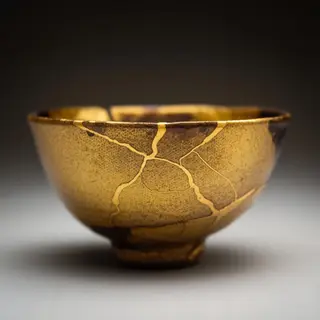 A Japanese kintsugi bowl — cracked ceramic repaired with vis